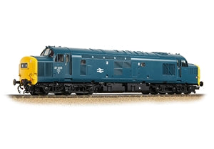 A model diesel locomotive train in a dark teal blue livery with a bright yellow front and buffers, shown on a section of model track against a plain white background.