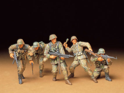 German model soldiers in camouflage uniforms with weapons on a brown surface