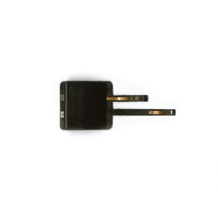 Black power clip for a model railway on a white background