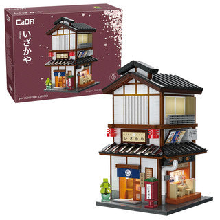 Model of a traditional Japanese building with packaging in the background