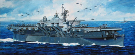 Dragon 1024 USS Independence  a large grey aircraft carrier at sea with multiple fighter jets flying overhead, under a blue sky with white clouds.