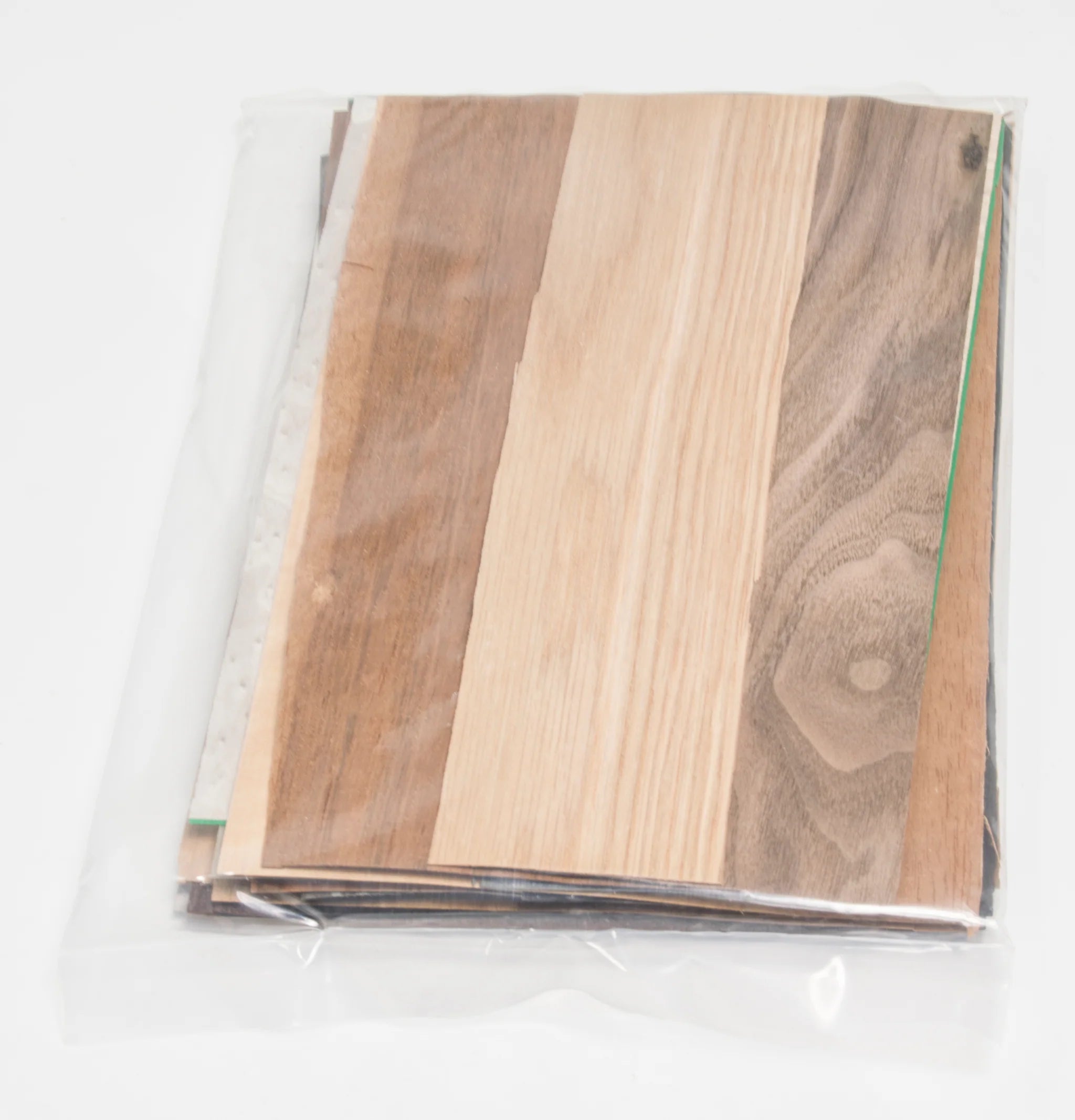 assorted marquetry veneer 12" lengths in a plastic cover on a white background