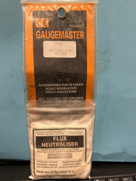 Packaged Gaugemaster flux neutralizer on a blue surface
