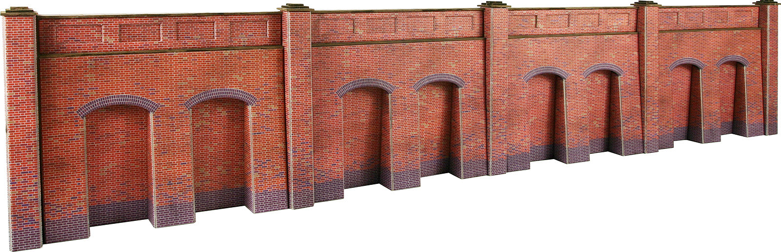 A long brick wall panel or miniature diorama wall section with repeating arched openings, shown on a plain white background.