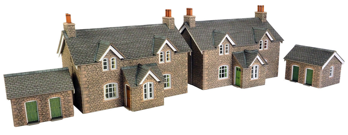 Model houses with grey roofs and green doors on a white background