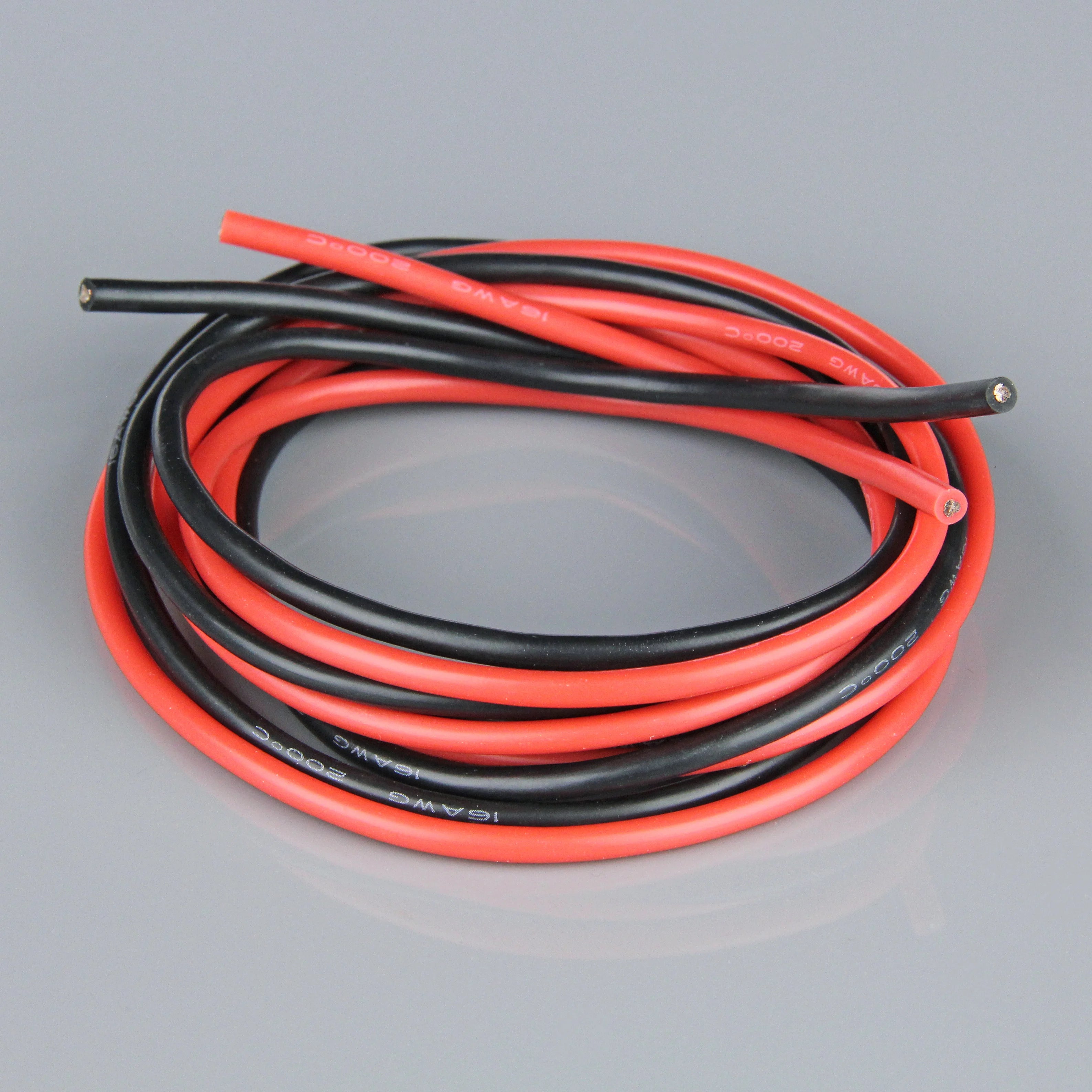 A coiled pair of 16AWG Silcone wire, featuring one red cable and one black cable, with bare metal wire ends visible, set against a neutral gray background.