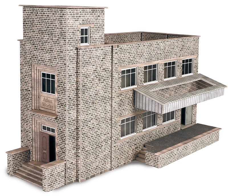 Card model of a two-story brick  factory building with a front porch on a white background