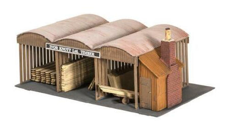 Model of a wooden shed with stacked timber and a sign on a white background
