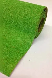 Roll of green carpeting on a white background