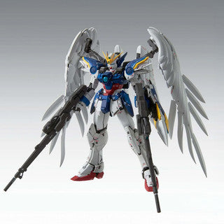 Model kit of a Gundam mecha with wings in a dynamic action pose on a grey background