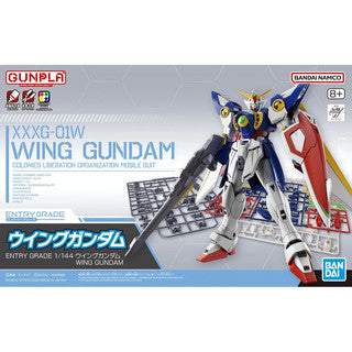 Model kit packaging of Wing Gundam with Gunpla and Bandai Namco branding.