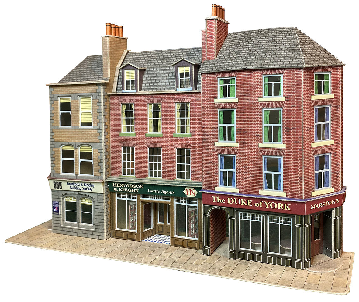 A card kit model of a three-story brick building facade, featuring 'The DURE of YORK' and 'MOUNTAIN'S' storefronts on a clean white background.
